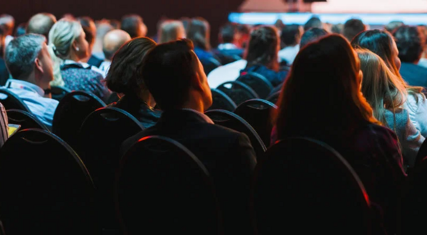 Rear view of audience viewing/listening to a lecture