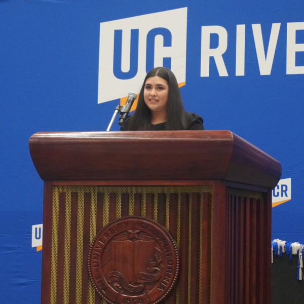 University Honors Valedictorian Jennifer Ibarra delivering valedictory speech at podium