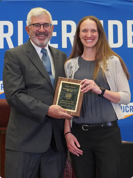 Dr. Richard Cardullo awards Dr. Bree Lang Professor of the Year plaque